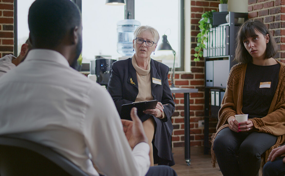 African american man talking to counselor about addiction at aa therapy meeting