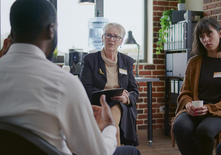 African american man talking to counselor about addiction at aa therapy meeting