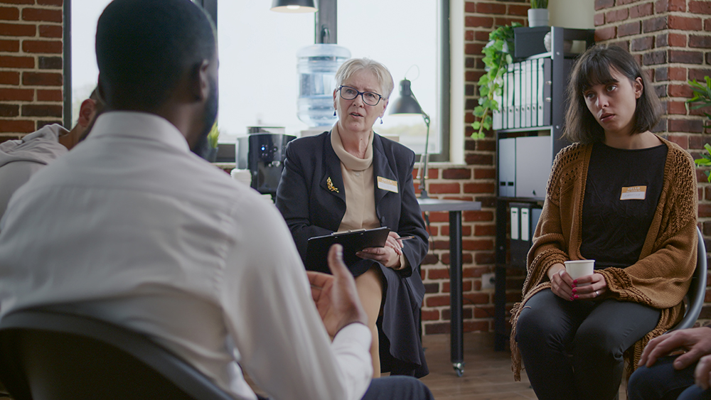 African american man talking to counselor about addiction at aa therapy meeting